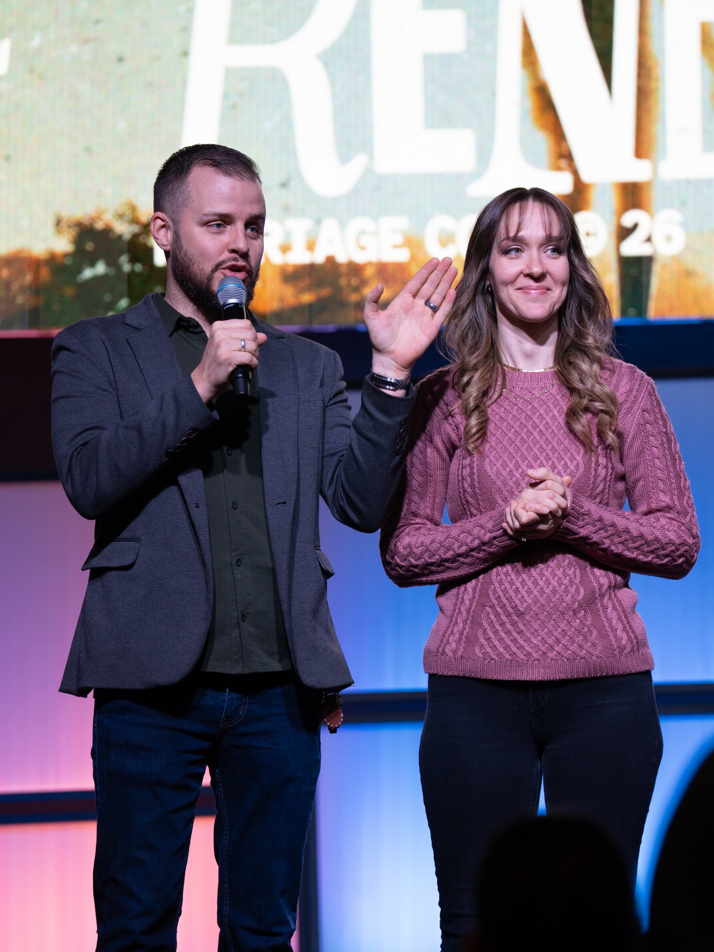 Austin and Rachel Holt speaking on stage